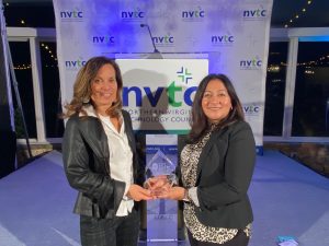 Trisann Ferrigno of Stack Infrastructure and Lillian Rivera of Bureau Veritas accept the Data Center Community Champion Award on behalf of the 7x24 Exchange Greater Washington DC Chapter